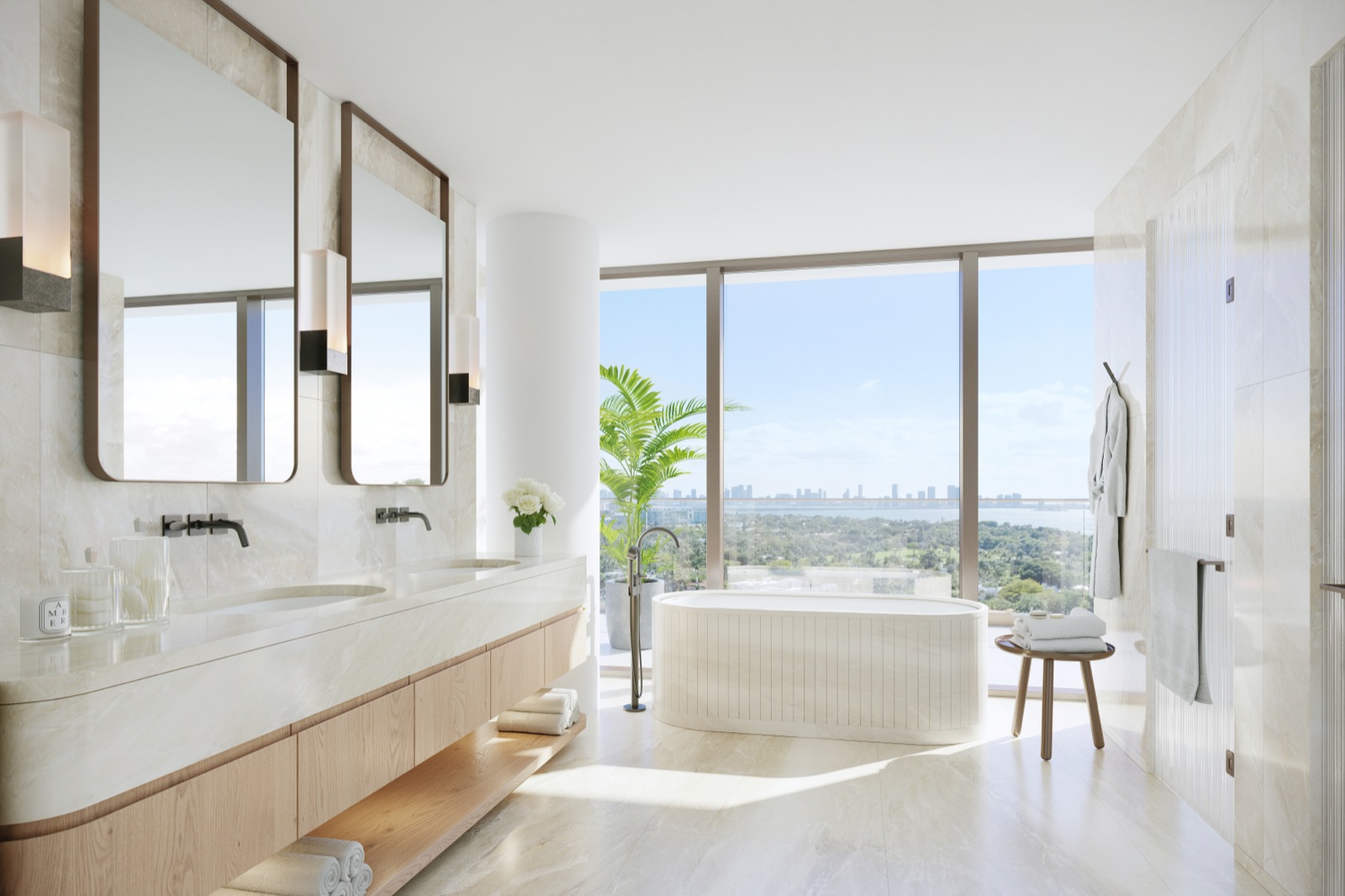 The Perigon penthouse primary bath in natural stone with custom bathtub, bespoke mirrors and lighting.
